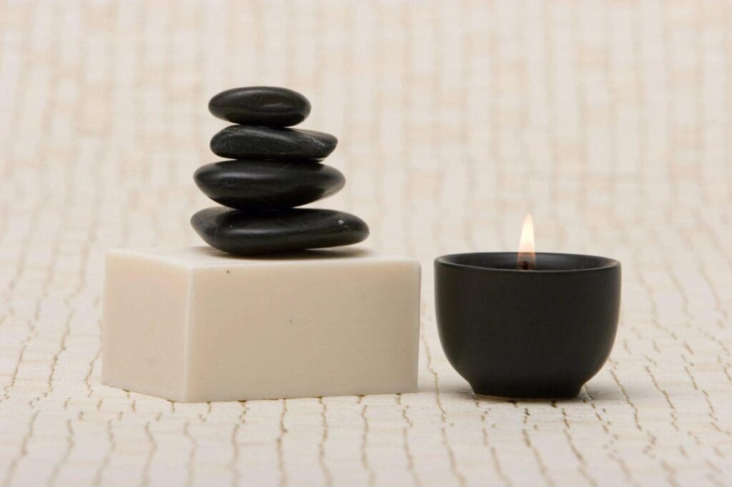 A candle and some rocks on the floor