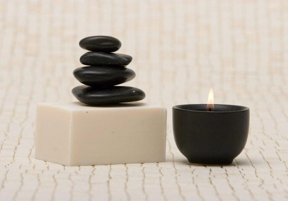 A candle and some rocks on the floor